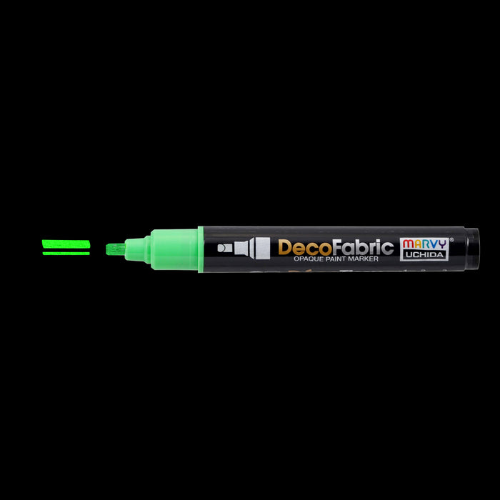 Decofabric marker fluorescent green with cap off and a color line at tip with black background