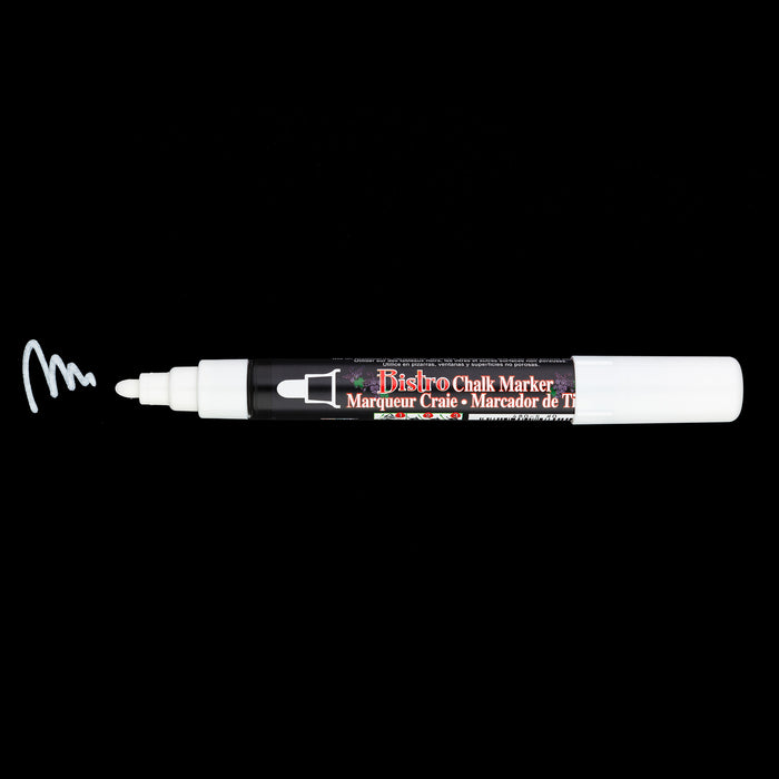 Bistro chalk broad tip white with cap off showing ink color on a black background.