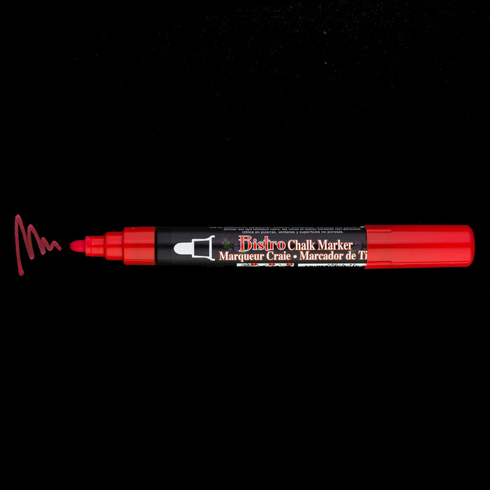 Bistro chalk broad tip red with cap off showing ink color on a black background.