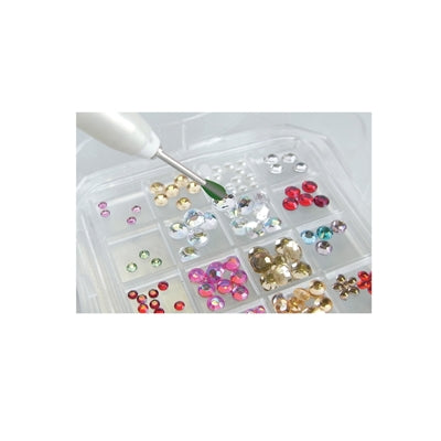 Jewel picker tip picking up a gem stone